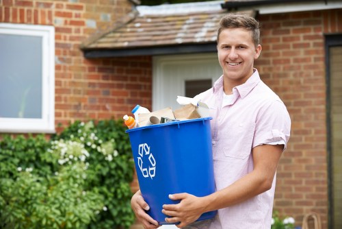 Workers wearing PPE handling commercial waste and using trolleys